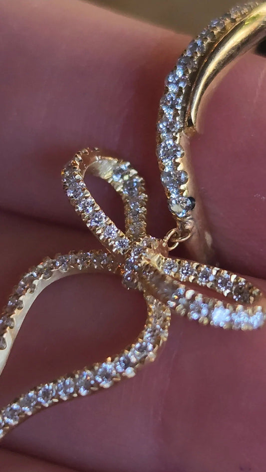 Close up of pavé diamonds on a Wavy Bow Diamond Hoop in 18K yellow gold, for the Los Angeles creative woman