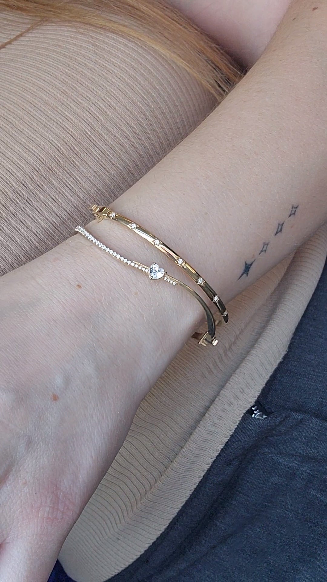 Wavy diamond bangles in gold stacked on the wrist, a freedom essay for the ambitious woman in Miami